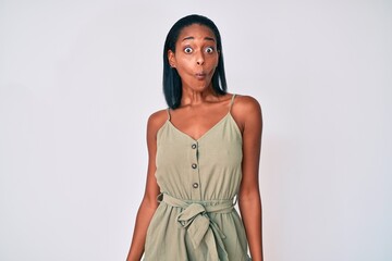 Young african american woman wearing casual clothes making fish face with lips, crazy and comical gesture. funny expression.