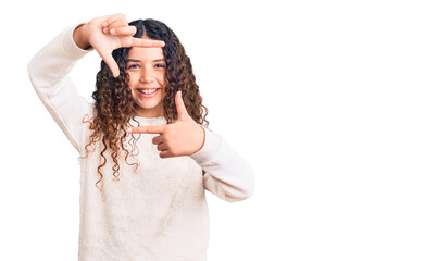 Naklejka premium Beautiful kid girl with curly hair wearing casual clothes smiling making frame with hands and fingers with happy face. creativity and photography concept.