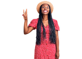 Young african american woman wearing summer hat showing and pointing up with fingers number three while smiling confident and happy.