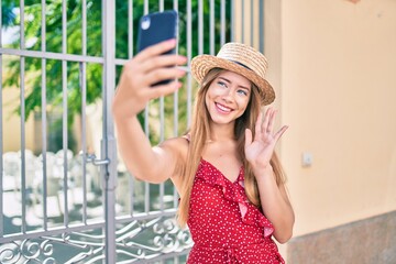 Young caucasian tourist girl smiling happy doing video call using smartphone at the city.