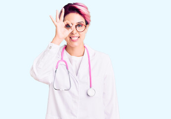 Young beautiful woman with pink hair wearing doctor uniform doing ok gesture with hand smiling, eye...