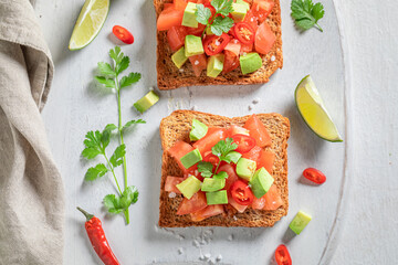 Tasty Toast made of tomatoes, chilli pepper and avocado