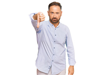 Handsome middle age man wearing business shirt looking unhappy and angry showing rejection and...