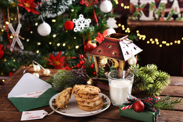 glass of milk and cookies on wooden table for Santa Claus