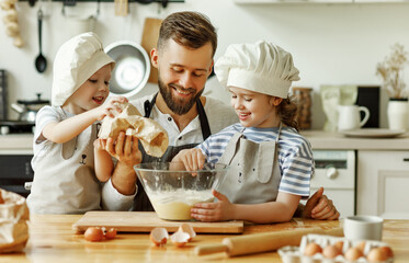 Father and kids preparing pastry together.