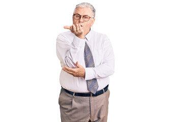 Senior grey-haired man wearing business clothes looking at the camera blowing a kiss with hand on air being lovely and sexy. love expression.