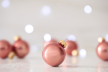 Fototapeta na wymiar Beautiful Christmas ball on table against blurred festive lights. Space for text