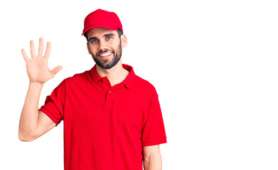 Young handsome man with beard wearing delivery uniform showing and pointing up with fingers number five while smiling confident and happy.