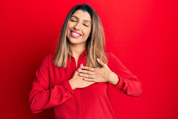 Beautiful brunette woman wearing casual clothes smiling with hands on chest, eyes closed with grateful gesture on face. health concept.