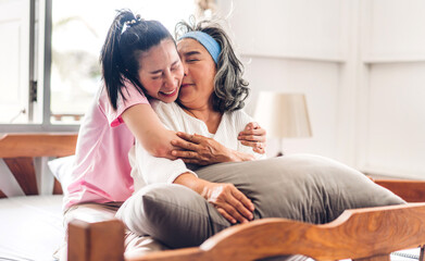 Portrait of enjoy happy love asian family senior mature mother and young daughter smiling laughing embracing and having fun together in moments good time at home