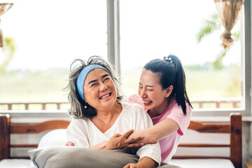 Portrait of enjoy happy love asian family senior mature mother and young daughter smiling laughing embracing and having fun together in moments good time at home