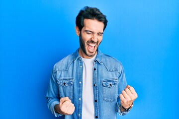 Young hispanic man wearing casual clothes celebrating surprised and amazed for success with arms raised and eyes closed