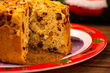 Fruit panettone topped with chestnuts on a plate decorated for Christmas
