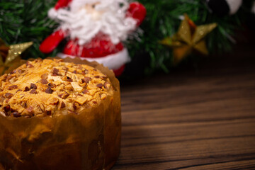 Fruit panettone covered with chestnuts on wooden table decorated for Christmas. Selective focus.