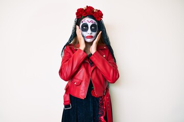 Fototapeta premium Woman wearing day of the dead costume over white tired hands covering face, depression and sadness, upset and irritated for problem