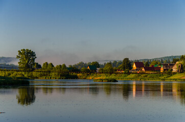 houses on the beach. Rural river in the early morning