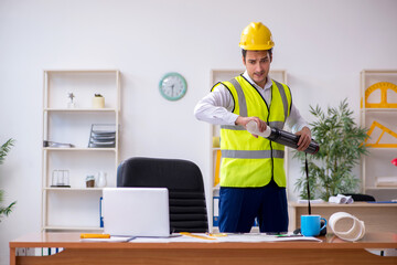 Young male architect working in the office