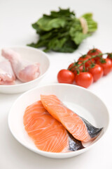 slice of salmon and chicken with vegetables