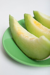 slice of melon on green plate