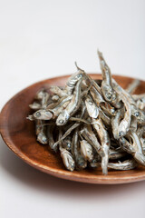 dried anchovies on wooden plate