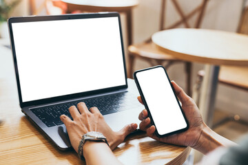 computer,cell phone mockup.hand woman work using laptop texting mobile.blank screen with white background for advertising,contact business search information on desk in cafe.marketing,design