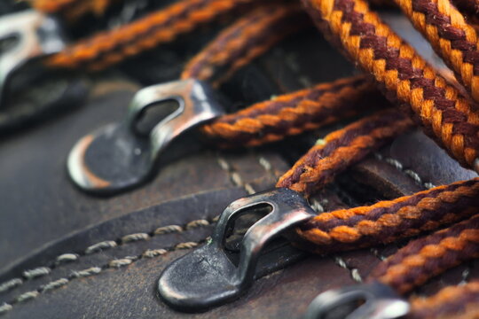Metal buckles of work leather shoes with tied laces close up. Shallow DOF