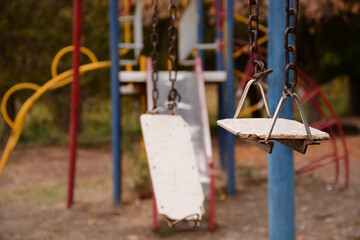 rusty old swing on abandoned playground