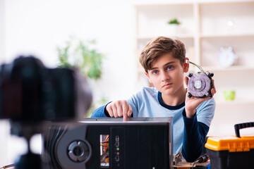 Boy computer repairman recording video for his blog