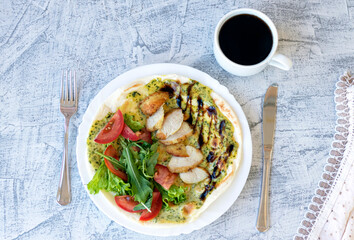 Italian breakfast with coffee. Piadina with grilled chicken, tomatoes, salad and arugula. Delicious breakfast. Soft focus. Top view