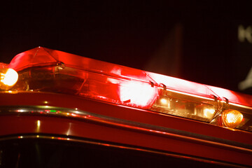 Isolated close up of fire truck flashing light bar at night