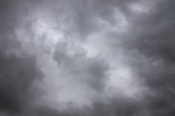 black and white storm clouds background. Light in the Dark and Dramatic Storm Clouds background, Dark clouds before a thunder-storm.