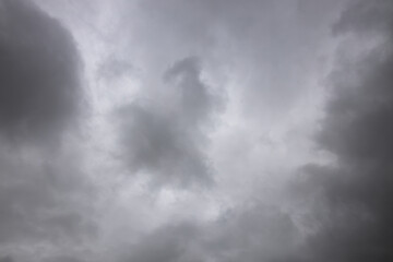 black and white storm clouds background. Light in the Dark and Dramatic Storm Clouds background, Dark clouds before a thunder-storm.
