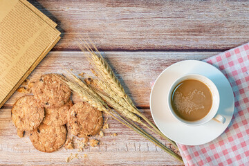 Coffee in a white cup and oatmeal cookies.