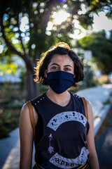 young beautiful girl with face mask back at school after covid-19 quarantine and lockdown.