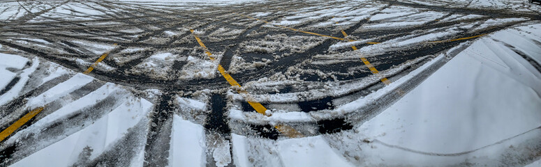 Panoramic view of a parking lot after a snow storm with crisscrossing lines © Lost_in_the_Midwest