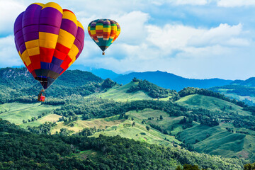Colorful hot air balloons flying over mountain at  pai mae hong son Thailand.