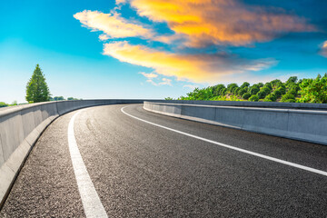 Fototapeta premium Countryside asphalt road and green tea plantations with mountain natural scenery in Hangzhou at sunrise.