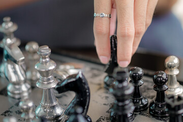 close-up of hand playing chess