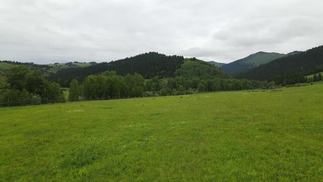 Landscape East Kazakhstan Upper Katon Karagay. Drone flight on DJI Mavic Air2, video 4K. River, green lowland near the mountains.