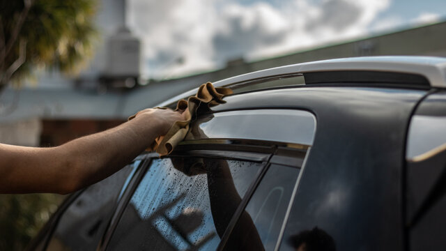 close up of a men wahing a car