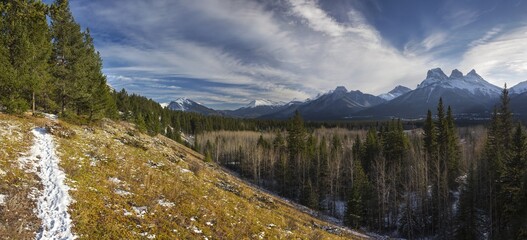 Snowy Hiking Trail and Distant Rocky Mountain Peaks Panoramic Landscape above Bow Valley, Alberta Foothills of Canadian Rockies