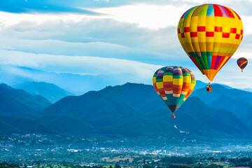 Colorful hot air balloons flying over mountain at  pai mae hong son Thailand.