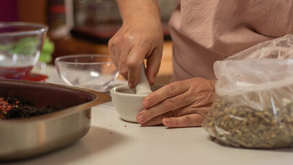 Obraz na płótnie Canvas close up of a woman making a tea blend