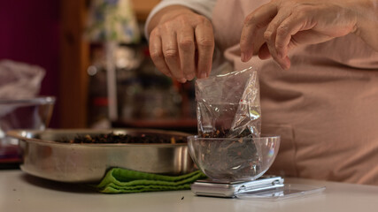 close up of a woman making a tea blend