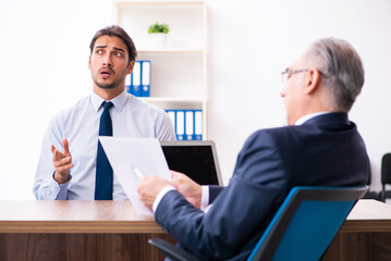 Young male candidate employee meeting with old recruiter