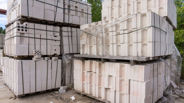 Packed with bandage tapes and stretch film bricks are stacked on wooden pallets in an abandoned warehouse