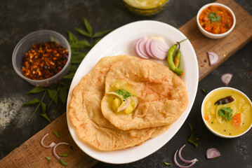 Puri Bhaji North India Poori is breakfast food a deep fried bread made from whole wheat flour Served with dal curry, Potato curry , bhaji , Kerala,  Mumbai , India	
