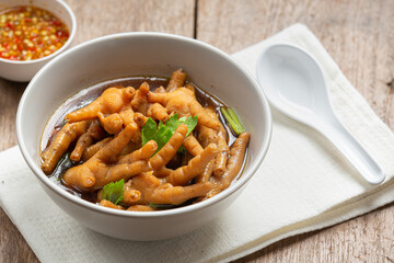 thai food ; Stewed Chicken Feet soup served with spicy fish sauce