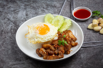 Thai food;  fried pork with garlic and pepper served with rice and fried egg