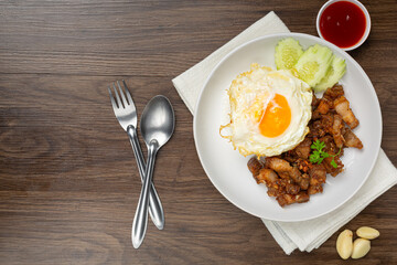 Thai food;  fried pork with garlic and pepper served with rice and fried egg